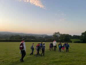 Highweek Scouts on a night hike in Denbury (at dusk)